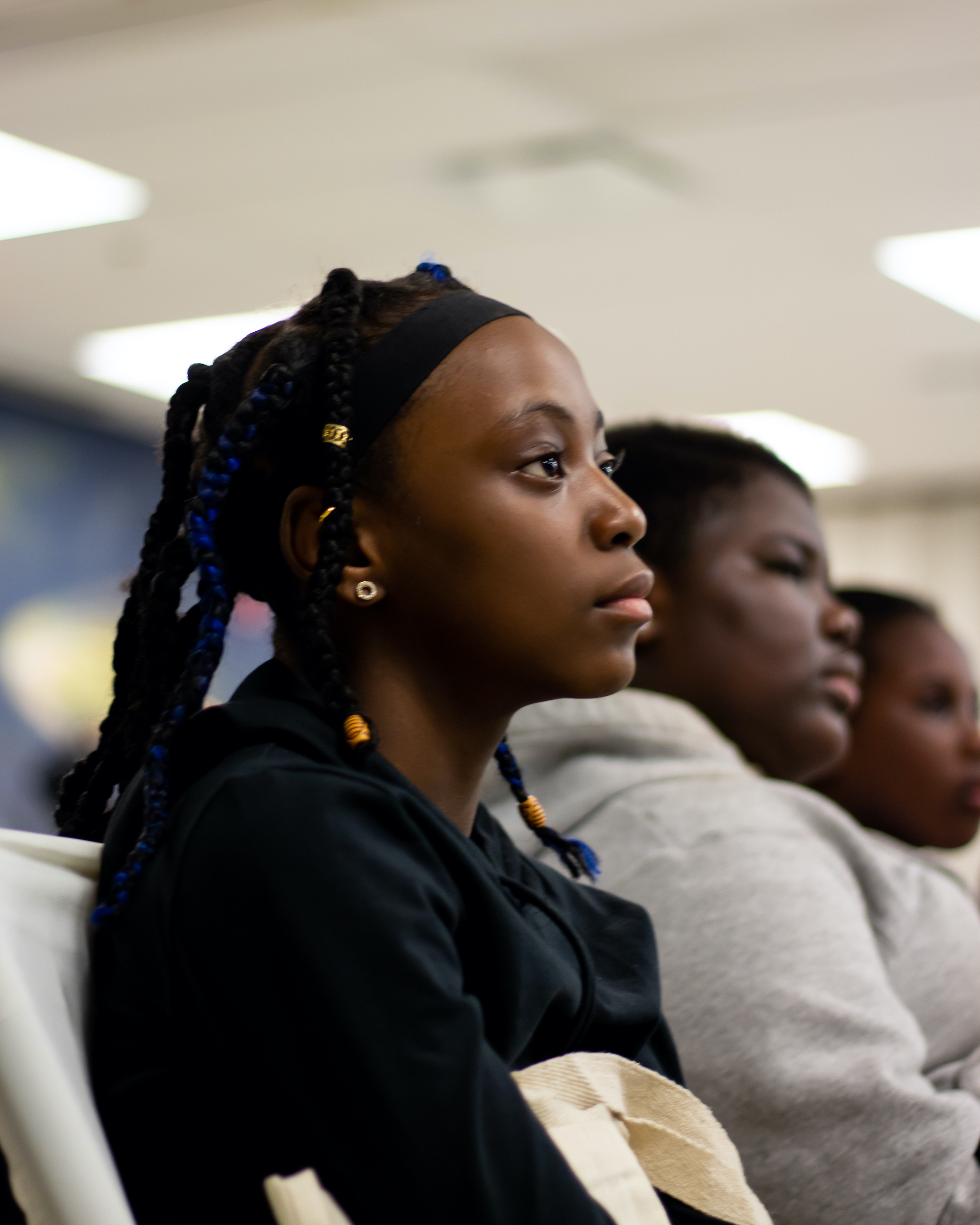 Young Black girl watching a Power to Girls presentation