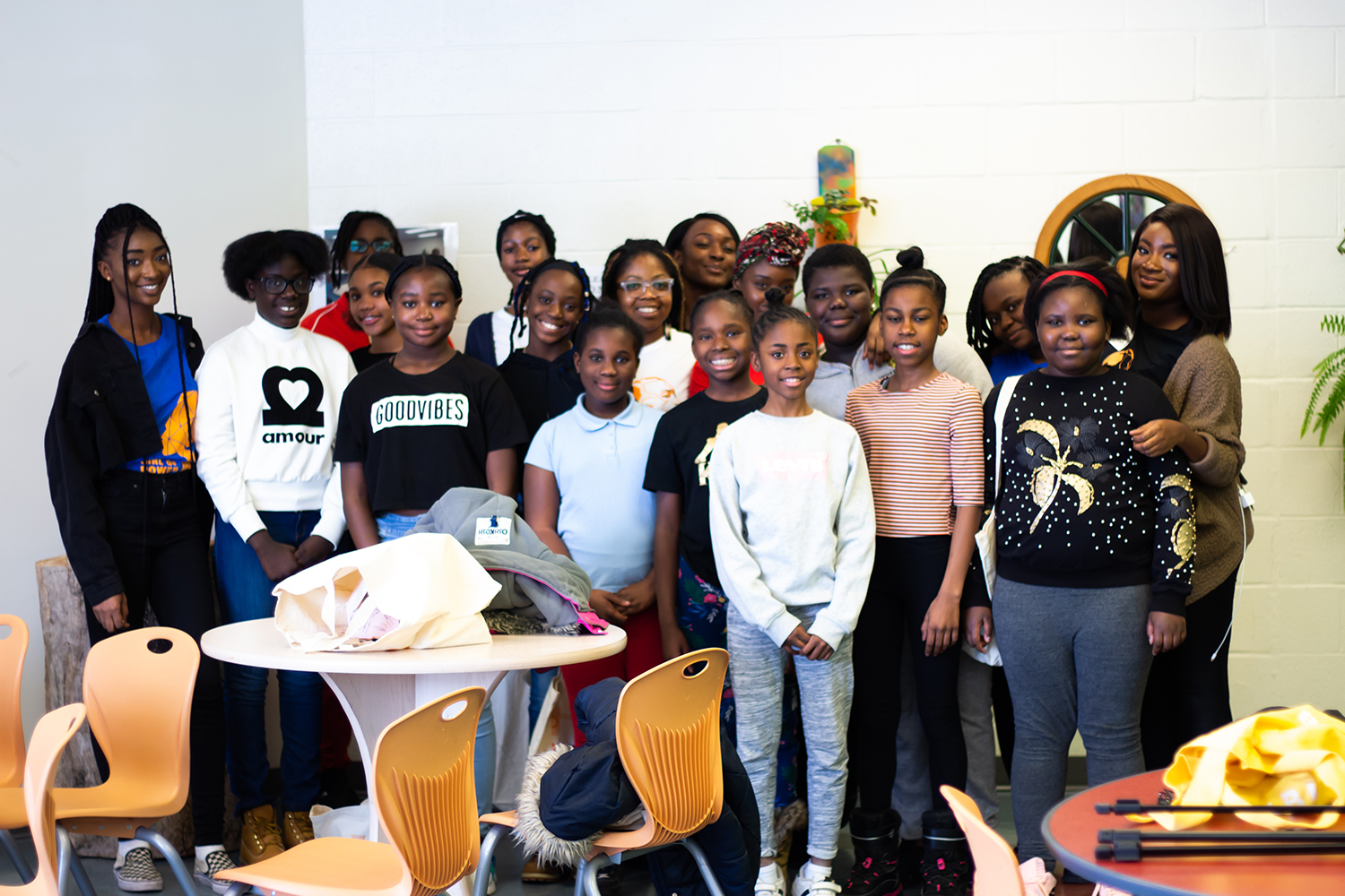 Group of young Black girls posing for the camera at a Power to Girls workshop.